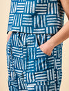 Blue and white patterned pants made using Sepia Pants and Shorts sewing pattern with a beige background