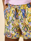 Colorful paisley-patterned shorts made using Sepia Pants and Shorts sewing patternon a beige background