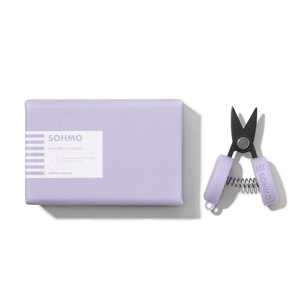 Purple pet nail clipper with packaging on a white background