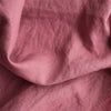 Close-up of Vintage Plum extra wide 100% linen fabric with visible texture