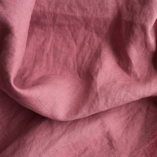 Close-up of Vintage Plum extra wide 100% linen fabric with visible texture