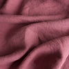 Close-up of Vintage Plum extra wide 100% linen fabric with visible texture