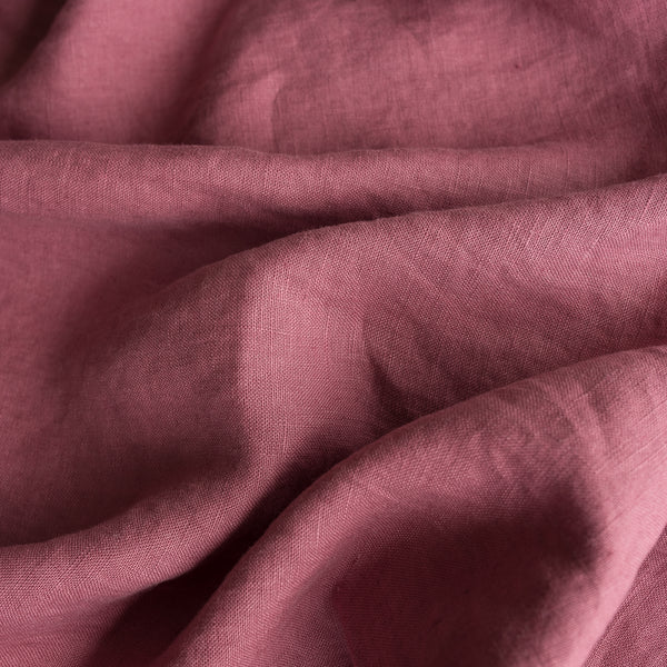 Close-up of Vintage Plum extra wide 100% linen fabric with visible texture