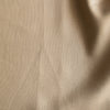 Close-up of Wheatfield Tan is a warm golden 100% linen fabric with folds