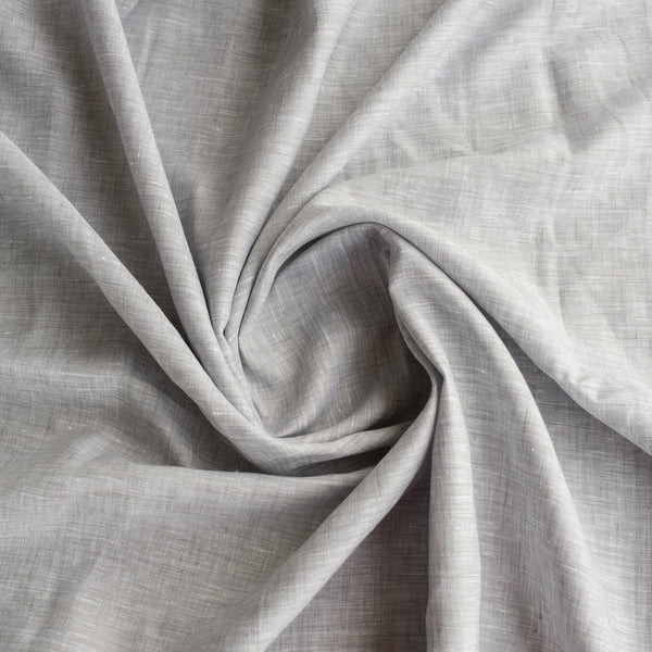 Sophisticated Chrome Grey Linen Fabric with a fine linen texture and a blend of white warp and grey weft, ideal for creating elegant and timeless clothing.