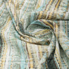 Lightweight linen-cotton blend fabric with scalloped, chevron, and striped patterns in green, yellow, maroon, and blue