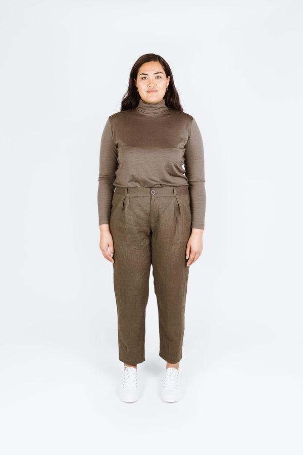 Guise Pants sewing pattern, featuring inverted pleats, zip fly, front and back pockets, and elasticated back, ideal for mid-weight woven fabrics like cotton, silk, and rayon.