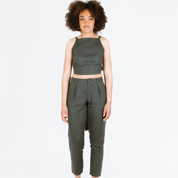 Guise Pants sewing pattern, featuring inverted pleats, zip fly, front and back pockets, and elasticated back, ideal for mid-weight woven fabrics like cotton, silk, and rayon.