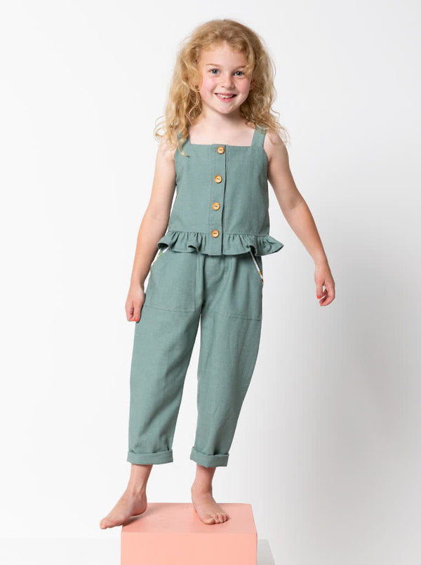 Kit Kids Tank Top sewing pattern, featuring a button-through top with frilled hem and adjustable shoulder straps for kids, suitable for linen, cotton, and denim fabrics.