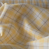 Summery Daffodil Check Linen Fabric with yellow and grey checks, offering a lightweight and delicate slub texture for airy summer garments.