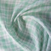 Summery Country Mint Check Linen Fabric with moss green and soft grey threads on a cream base, offering a smooth feel and gentle drape for comfortable wear.