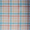 A close-up of the Multi Gingham 100% Linen Fabric showcasing its fine, yarn-dyed plaid pattern in blues, peaches, and creamy oatmeal