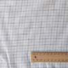 Rustic light check linen fabric with oatmeal and royal blue stripes on white background