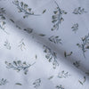 Soft green foliage patterns on white Leafy Whisper Linen Blend Fabric, 160 GSM, ideal for eco-friendly fashion and décor.