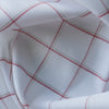 Harmony Checks Linen Blend Fabric. A lightweight linen-cotton blend fabric with a plaid pattern of thin red stripes forming a grid on a light beige background, indicating a composition of 52% linen and 48% cotton and a weight of 135 GSM.