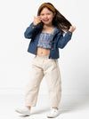 Kids’ shirred crop top with rouleau straps and balloon pants with ruffle and pockets sewing pattern, ideal for light woven fabrics.