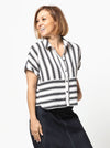 Lady wearing a black and white striped shirt made with the Blaire Shirt Sewing Pattern – Square-shaped with rolled cuffs and overlay.