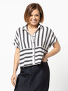 Lady wearing a black and white striped shirt made with the Blaire Shirt Sewing Pattern – Square-shaped with rolled cuffs and overlay.