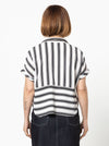 Lady wearing a black and white striped shirt made with the Blaire Shirt Sewing Pattern – Square-shaped with rolled cuffs and overlay.