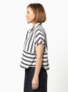 Lady wearing a black and white striped shirt made with the Blaire Shirt Sewing Pattern – Square-shaped with rolled cuffs and overlay.