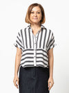 Lady wearing a black and white striped shirt made with the Blaire Shirt Sewing Pattern – Square-shaped with rolled cuffs and overlay.