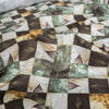 Nature-inspired Botanical Patchwork Linen Blend Fabric with green, beige, and brown leaf patterns