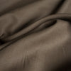 Close-up image of Burnt Umber 100% Linen Fabric, highlighting its substantial weight and rich dark brown color, ideal for various sewing projects.