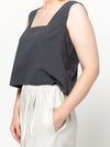 Image of the Byron Woven Top sewing pattern, highlighting the square neck, sleeveless design, and deep hem facing with topstitching, suitable for various elegant fabrics.