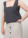 Image of the Byron Woven Top sewing pattern, highlighting the square neck, sleeveless design, and deep hem facing with topstitching, suitable for various elegant fabrics.