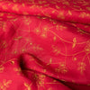 Elegant deep red linen fabric with dark golden floral embroidery, perfect for sophisticated projects.