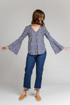 Dove blouse sewing pattern by Megan Nielsen with statement sleeve cuffs, french darts, v neckline, and curved hemline, available in three sleeve variations.