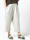 front view of Ethel Designer Pant sewing pattern by Style Arc, featuring elastic waist, dropped crotch, and balloon-shaped leg, suitable for linen, crepe, silk, and fine wool fabrics.