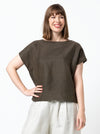 front view of lady wearing linen top made using Ethel Designer Top sewing pattern by Style Arc, featuring a square shape, angled design lines, and wide facings, suitable for linen, crepe, silk, and light wool fabrics.