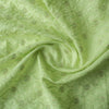 High-end vivid green linen fabric with subtle floral embroidery for luxury creations