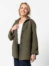 Logan Shacket sewing pattern, showcasing an oversized shirt-style jacket with dropped shoulders, large pockets, and twin needle topstitching, suitable for boiled wool, denim, corduroy, linen, or flannelette fabrics.