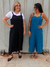 A casual Mildred jumpsuit sewing pattern with shoulder straps and wide legs, suitable for linen, cord, and denim fabrics.