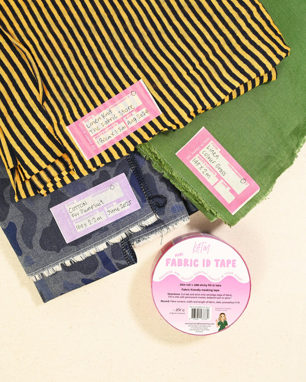 Fabric with different patterns and a roll of fabric tape on a beige background