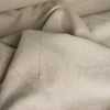 Oatmeal-colored medium-weight linen fabric with a fine weave and natural slubs.