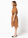 A sophisticated short-sleeved shirtmaker dress pattern featuring a collar stand, turn-back cuffs, and a shaped hemline, suitable for linen and other fabrics.