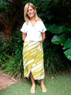 Stylish Rona Wrap Skirt sewing pattern with full faux wrap, calf-length cut, and front tie waist, suitable for rayon, crepe, silk, or washed linen fabrics.