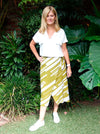 Stylish Rona Wrap Skirt sewing pattern with full faux wrap, calf-length cut, and front tie waist, suitable for rayon, crepe, silk, or washed linen fabrics.