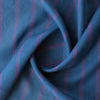 Tasman Tides linen fabric with deep blue base and vertical stripes in purple.