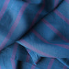 Tasman Tides linen fabric with deep blue base and vertical stripes in purple.