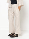 model wearing Albie Woven Pant and Short sewing pattern, highlighting elastic waist, straight wide leg, and optional pockets in front and back views.