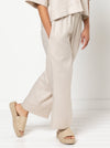 model wearing Albie Woven Pant and Short sewing pattern, highlighting elastic waist, straight wide leg, and optional pockets in front and back views.