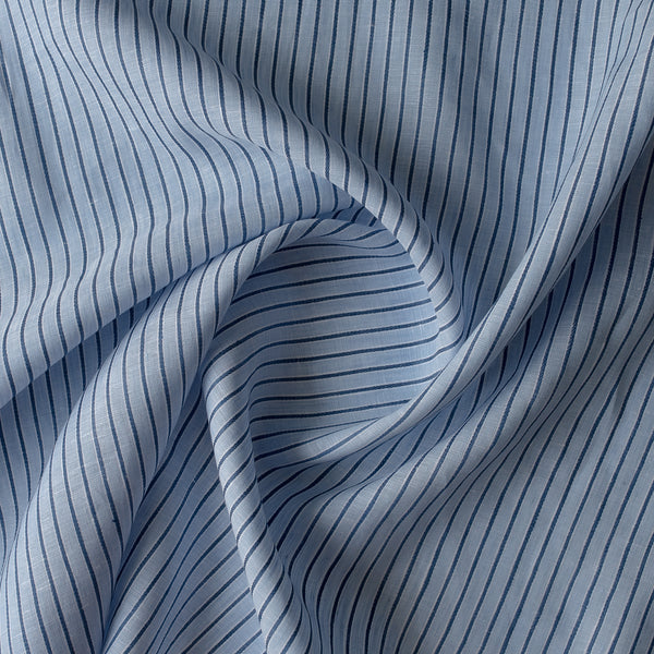 Close-up of Bluehaven Pinstripe linen fabric in pale blue with fine navy pinstripes, 100% linen, 140 GSM, 60 LEA yarn dyed
