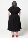 Person wearing a black dressmade using Bronte Woven Dress sewing patternwith a white background