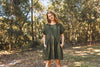 lady wearing green linen dress made using Fawn Dress Set Sewing Pattern - Versatile Dresses with Pockets in Two Bodice Styles