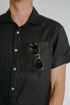 a man weariing black colour shirt made using Finch Men's Shirt Sewing Pattern - Button-Up Shirt with Scoop Back Hem