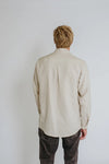 a man weariing off white colour shirt made using Finch Men's Shirt Sewing Pattern - Button-Up Shirt with Scoop Back Hem